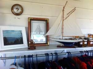 This here is one of the the two hand-crafted, wooden sail boats we have for sale. Both have a blue bottom and white sails. To the right of the boats is local Lion's Head made jams and jellies, including dandelion jam!